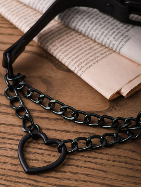 Dope Gothic Punk Leather Choker Necklace Featuring Adjustable Black Heart Chain on wooden table with newspaper background.