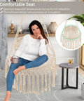 Macrame Swing Chair For Indoor Outdoor Living, Heavy Duty Hanging Porch Swing With Soft Cushions, Cotton Rope And Hardware Kits, Supports Up To 330 Lbs, Oval Hammock Style Chair For Patio Balcony Beige in living room