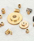Brass worm gear set components: gears and bushings for 20:1 reduction, top-down view.