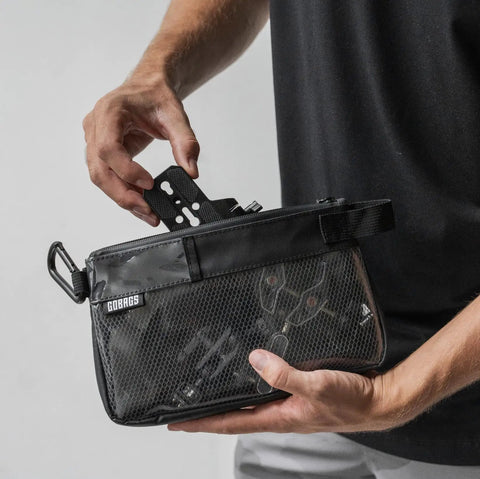 Person holding Small Black Electronics And Camera Accessories Bag With TPU Water Resistant Layer, Cable Organizer Pouch