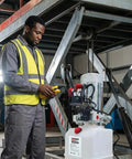 Worker operating Double Acting 12V DC Hydraulic Pump With 4 Quart Plastic Reservoir, 3200 PSI Power Unit, SAE6 Connector