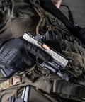 Person wearing 0.5mm AX-Suede Tactical Gloves With Tight Fit And Precision Feel For High Dexterity, holding pistol in tactical gear