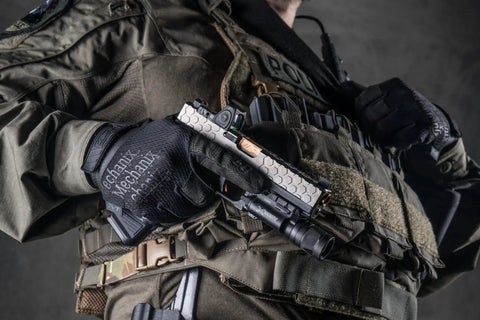 Person wearing 0.5mm AX-Suede Tactical Gloves With Tight Fit And Precision Feel For High Dexterity, holding pistol in tactical gear