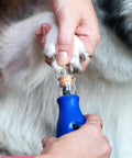 Person using the No-Fuss Rechargeable Pet Claw Grinder For Dogs And Cats Quiet Lightweight Rotary Nail Trimmer on a pet's paw.