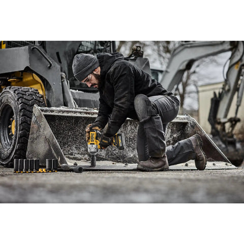 Worker using 20V Max XR Three Quarter Inch Cordless Impact Wrench Brushless Hog Ring Anvil High Torque Tool Only on machinery