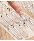 Heavy Duty Silicone Cabinet Door Bumpers, Ultra Grippy Self Adhesive Anticollision Tape, Pro Level Noise Dampening Pads For Kitchen Cabinets And Wood Furniture, Straight Up A Game Changer showing clear silicone bumpers being peeled from the sheet.