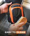 Cleaning Heavy Duty Knee Pads For Work And Home Use With Double Gel Comfort, showing water and brush on pad surface.