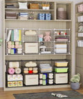 Interlocking Wire Cube Storage Unit And Divider System For A Versatile Modular Cabinet with white panels and small hooks.