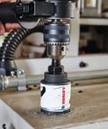 Lenox 2-3/4 in bi-metal speed-slot hole saw mounted on drill chuck (side view)