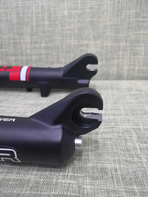 Close-up of Beefy Fat Tire Electric Bike Front Suspension Fork ends for 20 inch 4.0 wide tires, 135mm hub spacing, manual lockout.