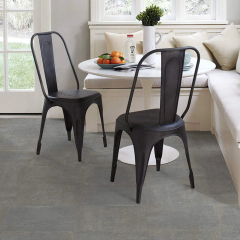 Dining area with metal chairs and a round table on Grey Tundra Peel And Stick Floor Tiles For Easy DIY Flooring Transformation.