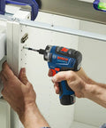 Man using 12V Max Brushless 1 Quarter Inch Hex Two Speed Screwdriver Kit With Dual 2.0Ah Batteries for DIY cabinet assembly