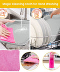 Magic cleaning cloth for hand washing and dishwasher use shown on stainless steel rack with dishes and pink cloth