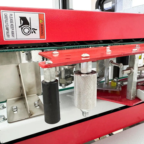 Close-up of Automatic Foam Box Side Sealing Machine 110V Built Tough Rubber Conveyor Belt Package Tape Sealer mechanism and rollers.