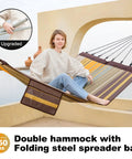 Person relaxing in 14 Foot Two Person Outdoor Hammock With Quick Dry Textilene Fabric, Portable No Stand Needed, Folding Steel Spreader Bar