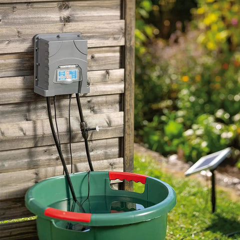 Solar Powered Automatic Drip Irrigation System With 50 Drippers And 155 Feet Of Tubing for Balcony Gardens next to a green basin