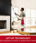 Person using Hassle Free Bagged Upright Vacuum With No Touch Auto Dump And Smooth Lift Up Pod For Stairs for above-floor cleaning.