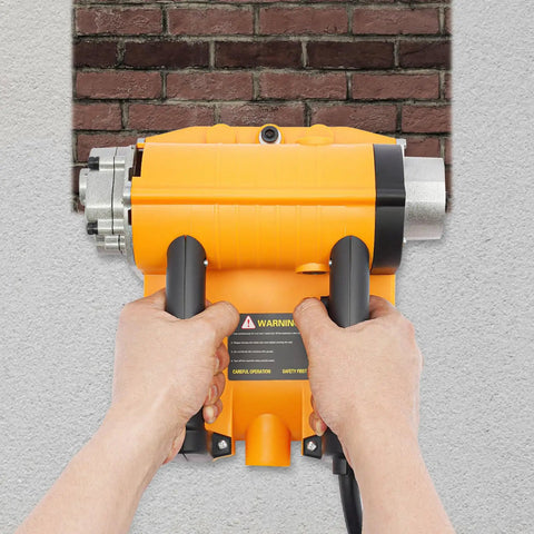 Hands holding a Heavy Duty Electric Wall Planer For Floor Tile Removal 4580W Motor 3500 RPM against a wall.