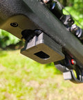 Close-up of Base Plate Grip For Ruger 10 22 Rotary Magazine in use, showing installation on rifle in grassy outdoor setting.