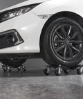 Heavy Duty Car Wheel Dollies Moving Cart With Locking Brakes supporting a car, showcasing 6000 lbs capacity and 3 inch casters.