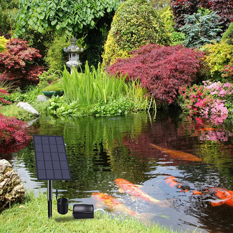 Solar Pond Aerator Low Noise Air Pump 2W IP64 Waterproof beside a pond with colorful koi fish and lush greenery.