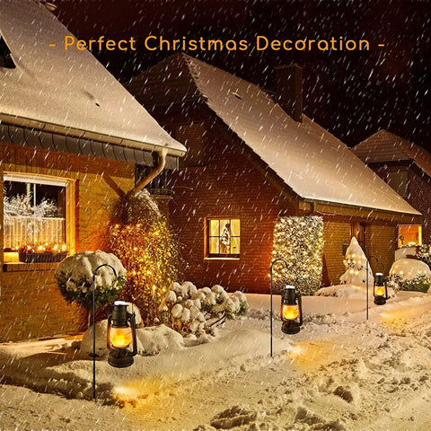 Battery Operated LED Vintage Lanterns With Remote illuminating snow-covered Christmas yard with rustic oil lantern look