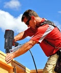 Worker using 9021N/NS 21 Degree Framing Nailer With Depth Adjustment, 3-1/2 Inch Nails on roof structure