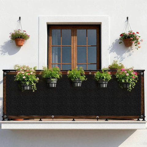 3x10 Black Fence Privacy Screen For Outdoor Shade And Balcony Decor on a balcony with hanging plants