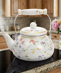 Vintage Floral Enamel Tea Kettle 2.6 Quart With Porcelain Handle For Stovetop Kitchen Camping And Home Gifts Perfect For Housewarming Wedding Bridal Shower Mothers Day Non Toxic Durable Fast Heating And Rust Resistant, displayed on a modern kitchen stovetop with floral design.