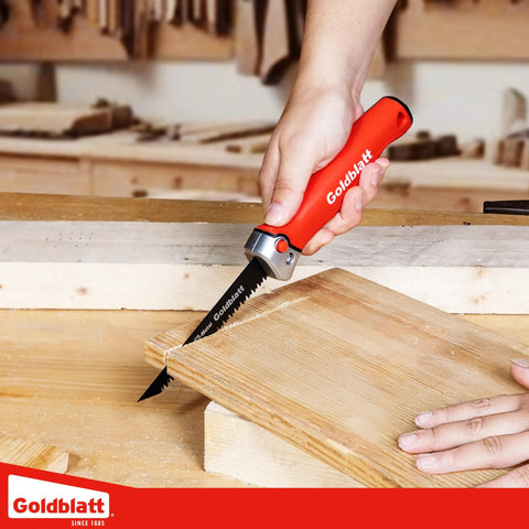Person using Folding Drywall Saw With Soft Grip Handle Jab Saw For Sheetrock Wallboard Plywood And PVC Pro Grade Tool with wood.