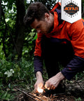 Man using Ultimate Go-To All Weather 5-In-1 Fire Starter Kit in forest with magnesium flint for camping and outdoors survival