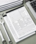 Twenty Pack 5.5 by 8.5 Inch Vehicle Inspection Report Books With 31 Sets Per Book 2 Ply Carbonless Yellow Copy Daily Pre Trip DVIR Forms For Fleet Inspections 310 Total Forms, stacked on desk