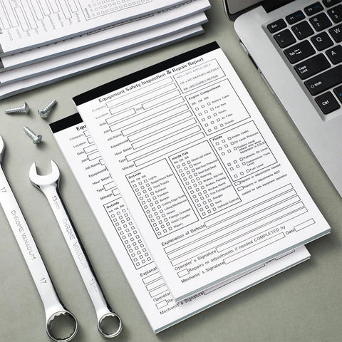 Twenty Pack 5.5 by 8.5 Inch Vehicle Inspection Report Books With 31 Sets Per Book 2 Ply Carbonless Yellow Copy Daily Pre Trip DVIR Forms For Fleet Inspections 310 Total Forms, stacked on desk