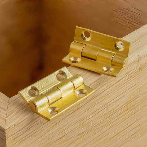 100 Pcs Mini Brass Hinges For Cabinets And DIY Projects, Gold Finish Small Butt Hinges 0.4 By 0.3 Inch, on a wooden surface