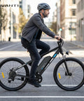 Adult Electric Mountain Bike With 26 Inch Tires And 750W Peak Motor in urban setting, featuring black aluminum frame and strong tires.