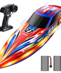 High Speed RC Boat For Kids And Adults, 25 Plus KPH Racing Power, LED Lights, Capsize Recovery, Dual 1300mAh Batteries, 2 4GHz Remote, Up To 30 Minute Run Time, 13 Inch Hull For Pool And Lake Fun shown with remote and batteries.