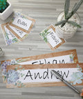 48 Pieces Rustic Bloom Name Tags Self Adhesive Labels With Succulent Theme for Desk Bulletin Boards and Classroom Decor shown on table