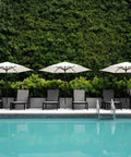 Poolside with Sturdy Stainless Steel Patio Umbrella Stand With Dual Mounting Options For Deck Or Concrete Granite Surfaces Planters Or Tires.