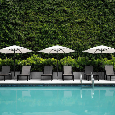 Poolside with Sturdy Stainless Steel Patio Umbrella Stand With Dual Mounting Options For Deck Or Concrete Granite Surfaces Planters Or Tires.