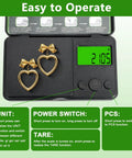 Portable Digital Pocket Scale 0.01 to 1000 g Precision Gram Scale With 7 Units And Tare Function LCD Display showing earrings