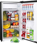 Upstreman 3.2 cu ft black mini fridge with freezer; single door with shelves holding fruits, vegetables, jars, and cans