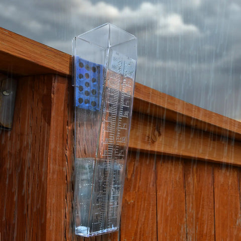 Rugged Outdoor Rain Gauge With 6 Inch Capacity For Yard Or Fence Post Mount Built Tough Weatherproof Construction Easy Install Dual Scale Inches And Millimeters For Quick Accurate Rain Readings mounted on a wooden fence in rain