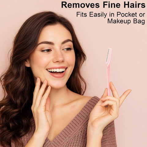 A close-up of a woman smiling, holding a pink eyebrow razor from the 3 Piece Unisex Eyebrow Razor Kit Makes Quick Work Of Stubborn Facial Hair While Doubling As A Smooth Dermaplaning Tool That Leaves Your Complexion Looking Fresh And Flawless.