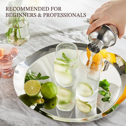 24 Ounce Cocktail Shaker Set With Bar Quality Strainer, Measuring Jigger, Mixing Spoon And Easy Recipe Guide For Beginners, Pro Grade Home Bar Kit In Silver pouring cocktails on a tray
