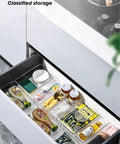 4 Pack Clear Drawer Organizers Set With Stackable Modular Bins Slim Profile For Kitchen Utensils Makeup And Office Supplies Interlocking Edges Non Slip Base Fits Dresser And Bathroom Cabinets in use within a kitchen drawer, holding assorted items neatly.
