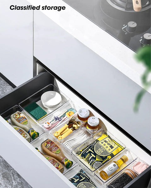 4 Pack Clear Drawer Organizers Set With Stackable Modular Bins Slim Profile For Kitchen Utensils Makeup And Office Supplies Interlocking Edges Non Slip Base Fits Dresser And Bathroom Cabinets in use within a kitchen drawer, holding assorted items neatly.