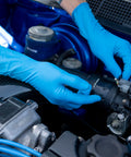 Person wearing Workhorse Grade 14 Mil Thick Blue Latex Heavy Duty Industrial Work Gloves With Rock Solid Textured Grip. Repairing an engine.