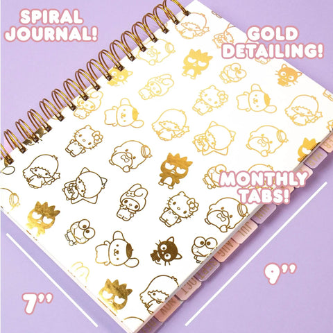 Hello Kitty Pink Gold Foil Journal Set For Girls with spiral binding, gold detailing, monthly tabs on purple background.