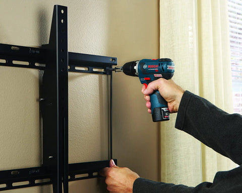 Person using 41 Piece Drill And Drive Set With Case For Wood Metal And Masonry Projects GoTo Bit Kit to install wall mount.