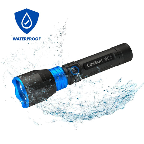 Black LED flashlight with blue accents labeled waterproof, splashed with water on a white background.